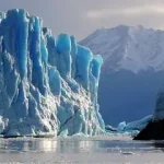Large glacier surrounded by snow-covered mountains